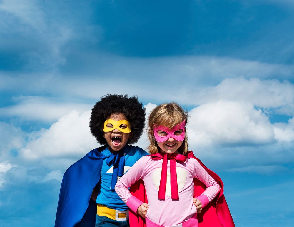 Boy with an afro and a blonde girl in superhero costumes