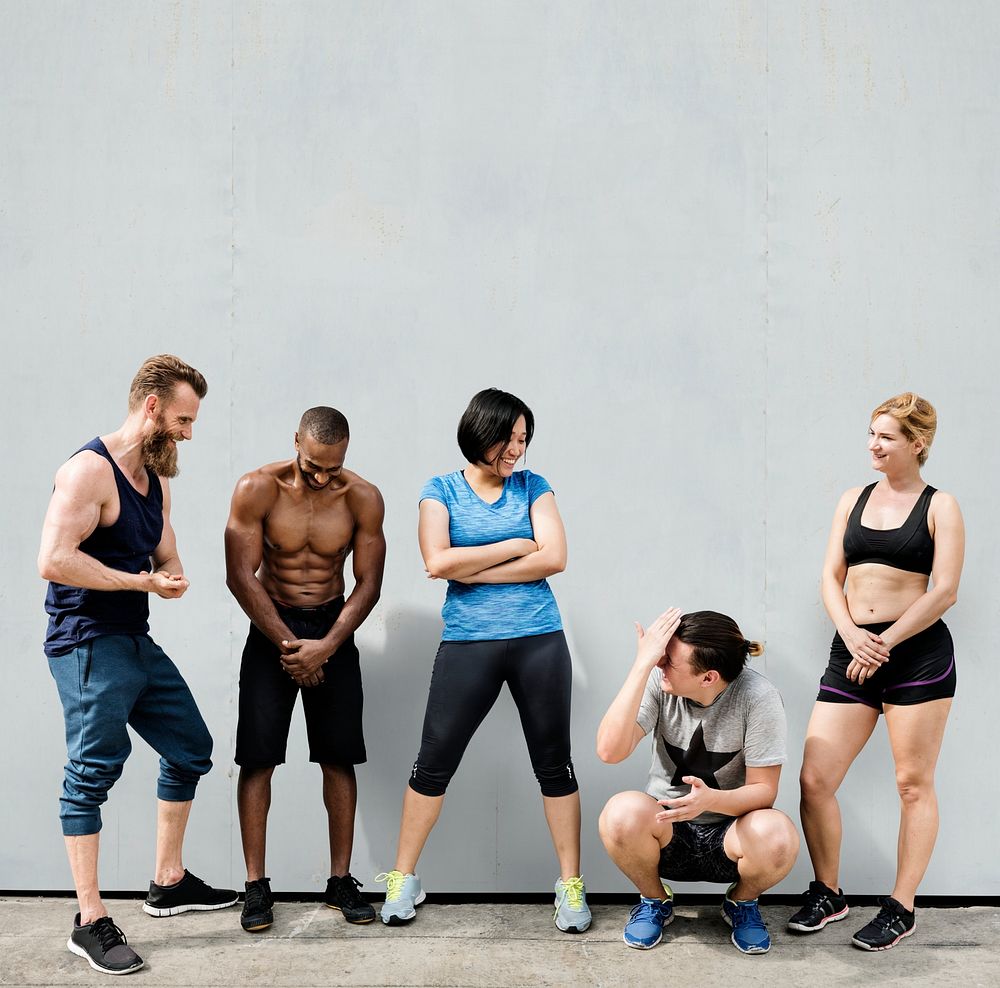Squad of active people in workout clothing