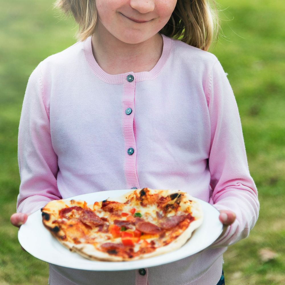 Child Holding Plate Pizza Concept