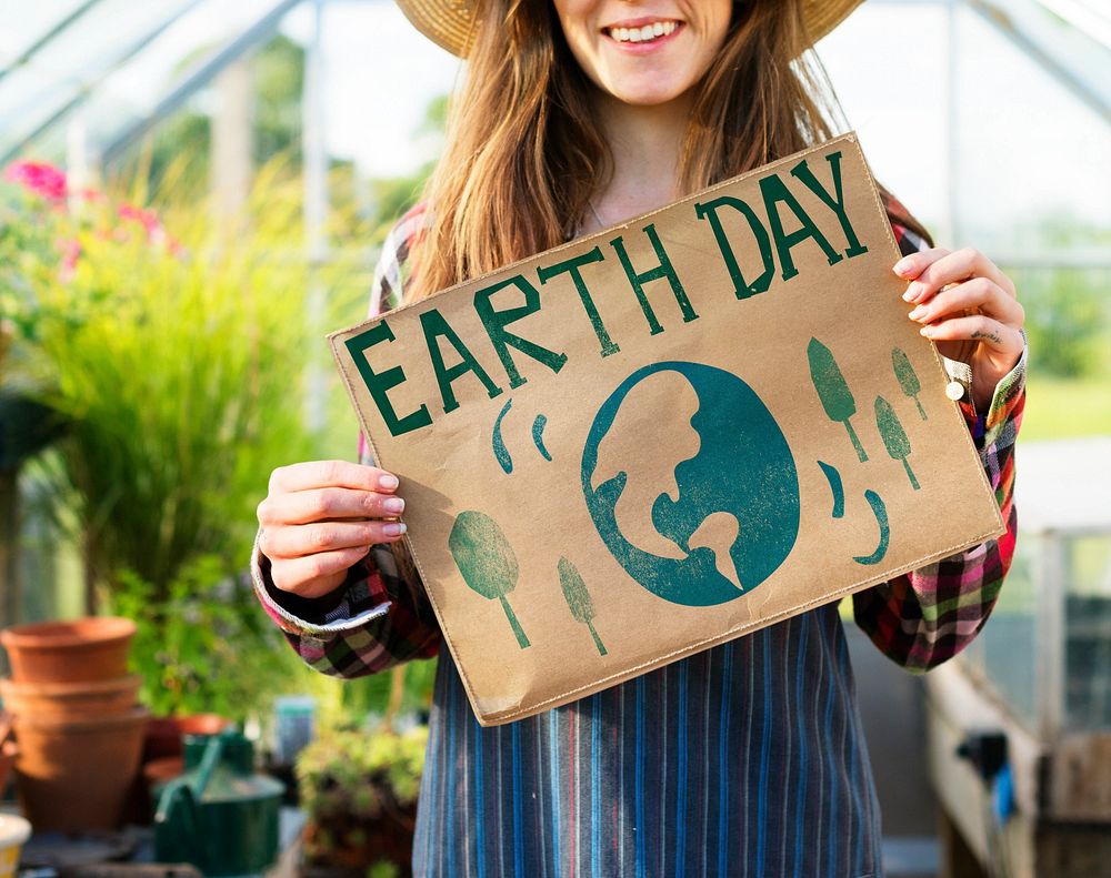 Young woman showing Earth Day poster