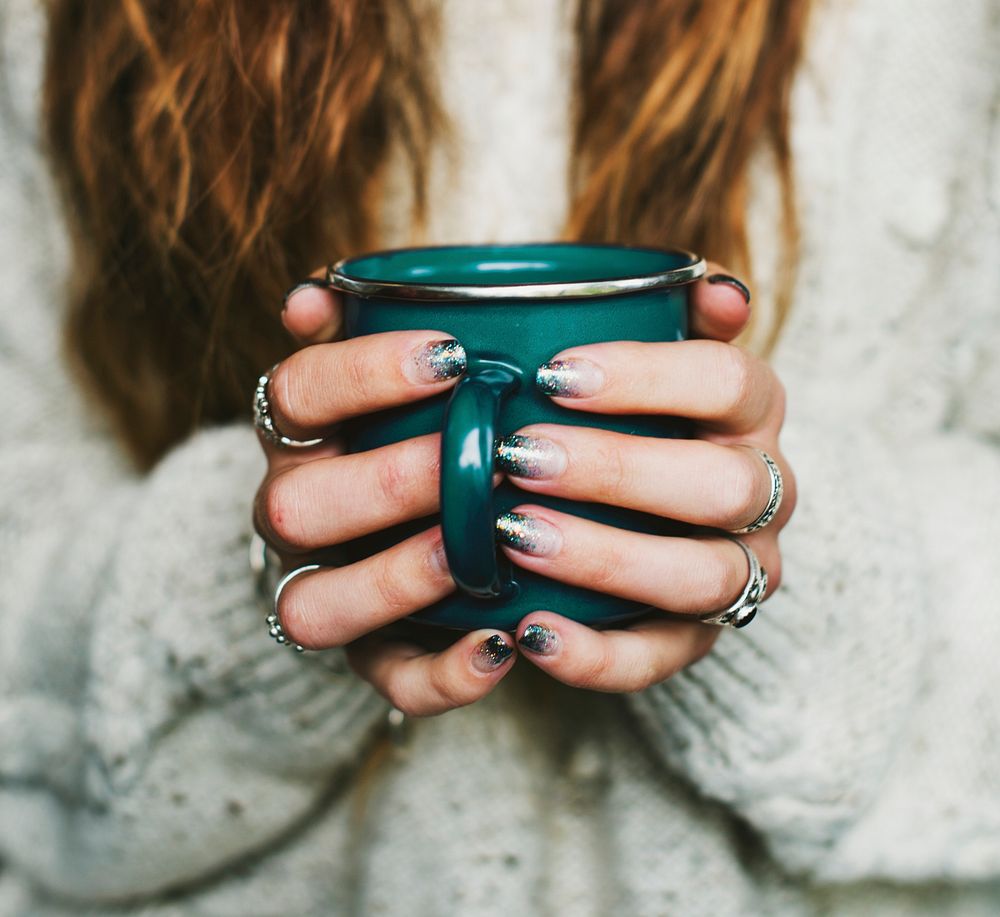 Closeup of hands holding coffee cup