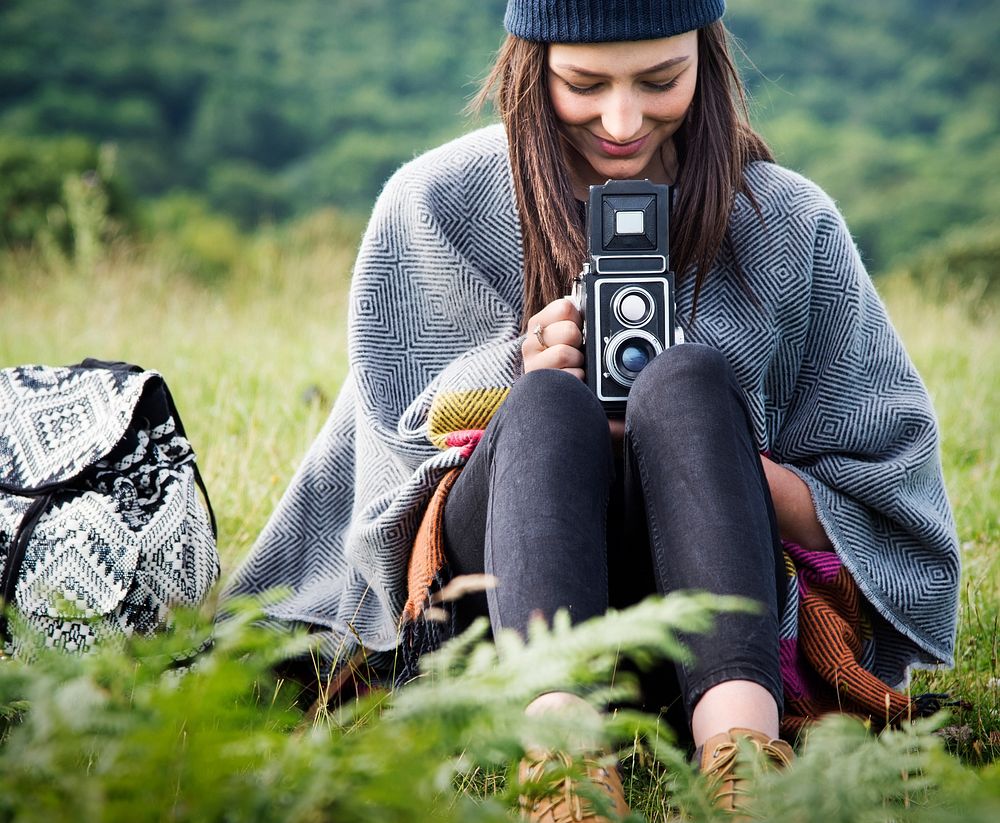 Woman with camera in the nature