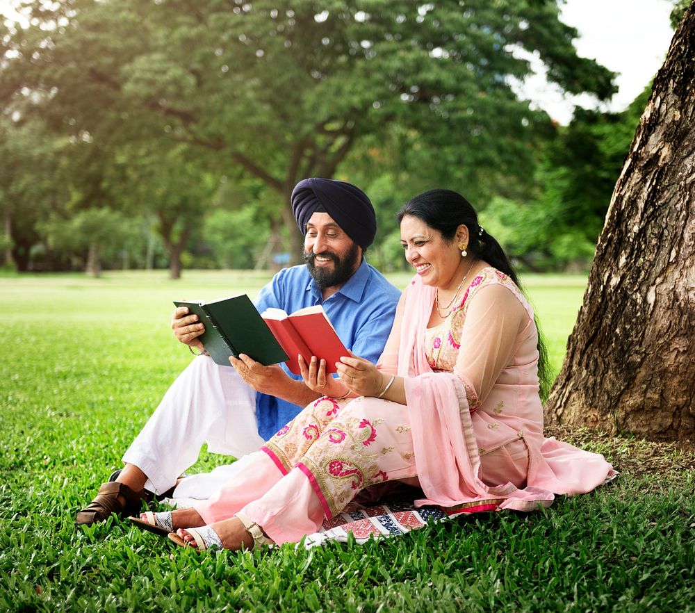 Loving senior Indian couple sitting in the park