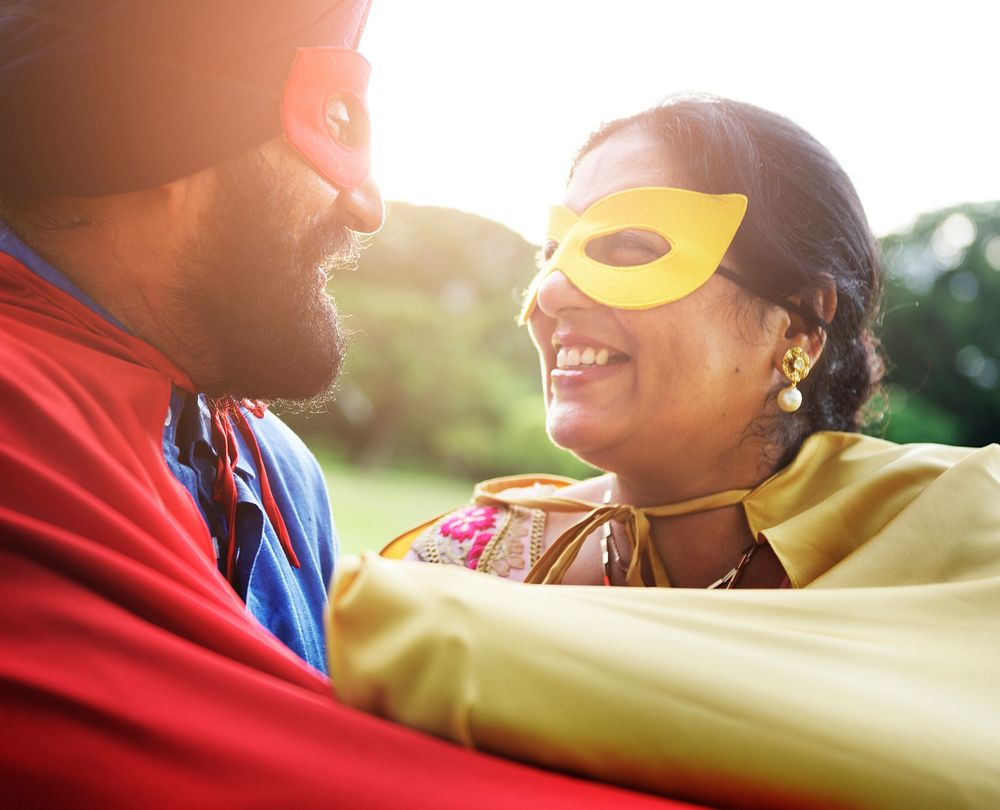 Loving senior Indian couple playing superheroes