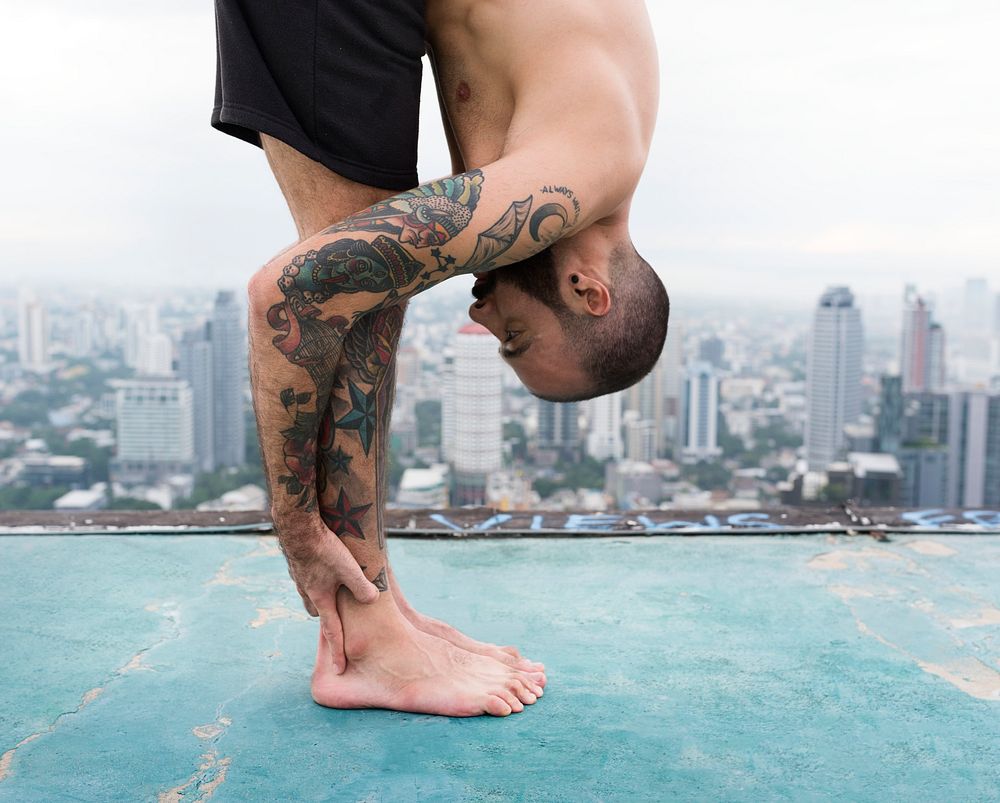 Man practicing yoga on a rooftop
