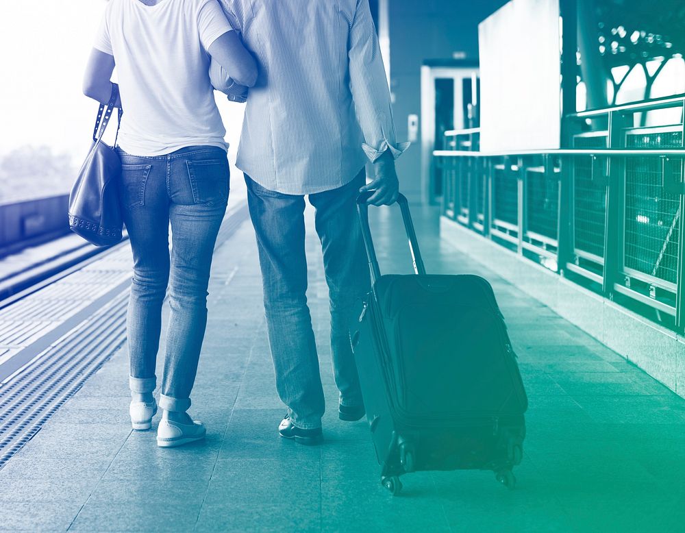 Senior adult couple with traveling luggage at train station