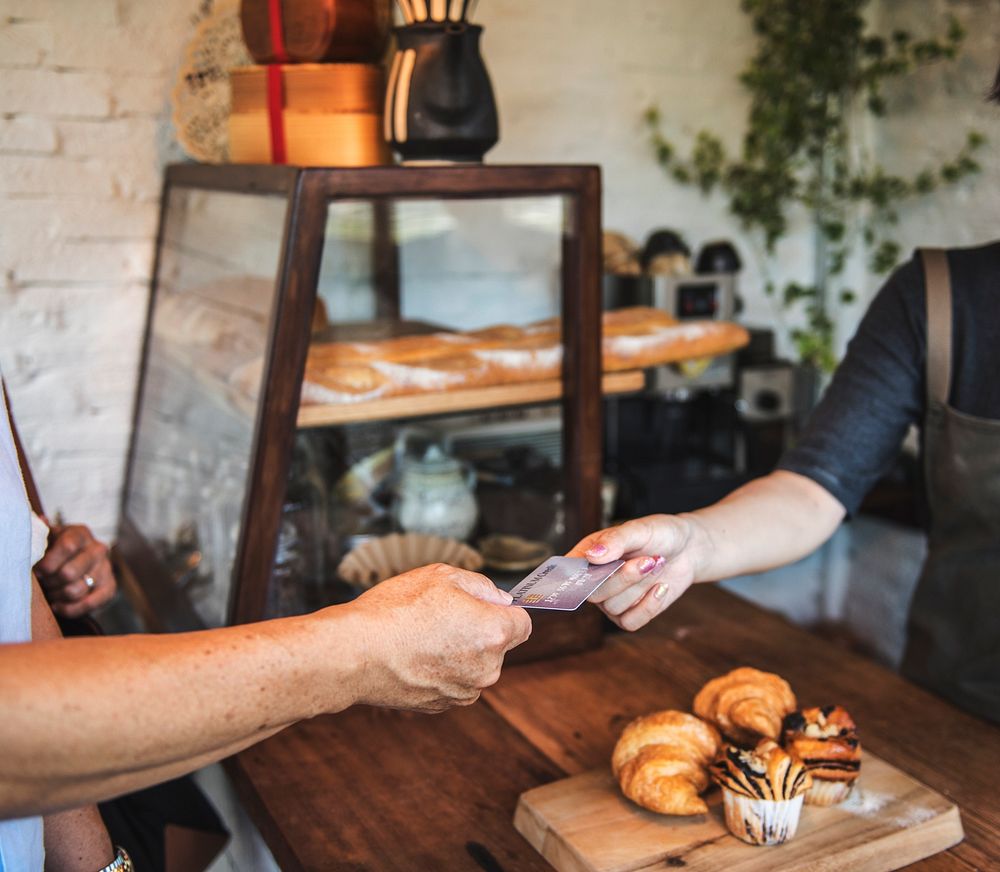 People hands credit card payment bakery