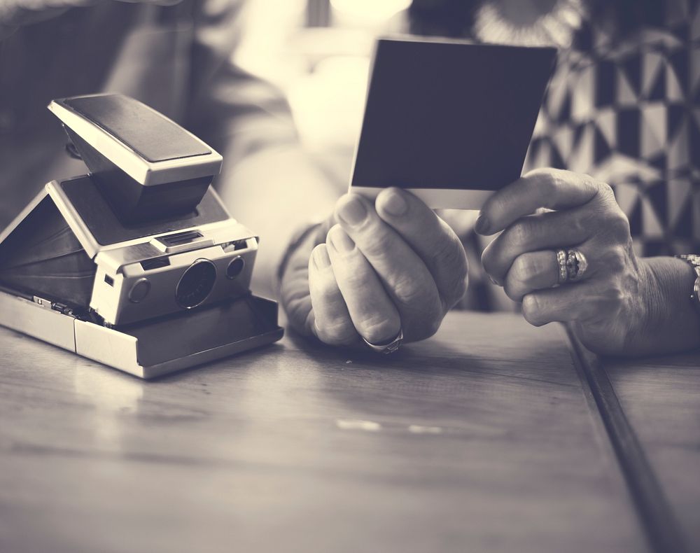 Close up couple checking instant camera image