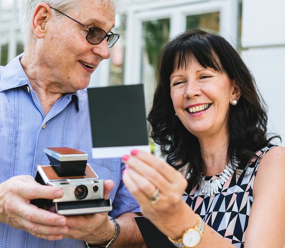 Close up couple checking instant camera image
