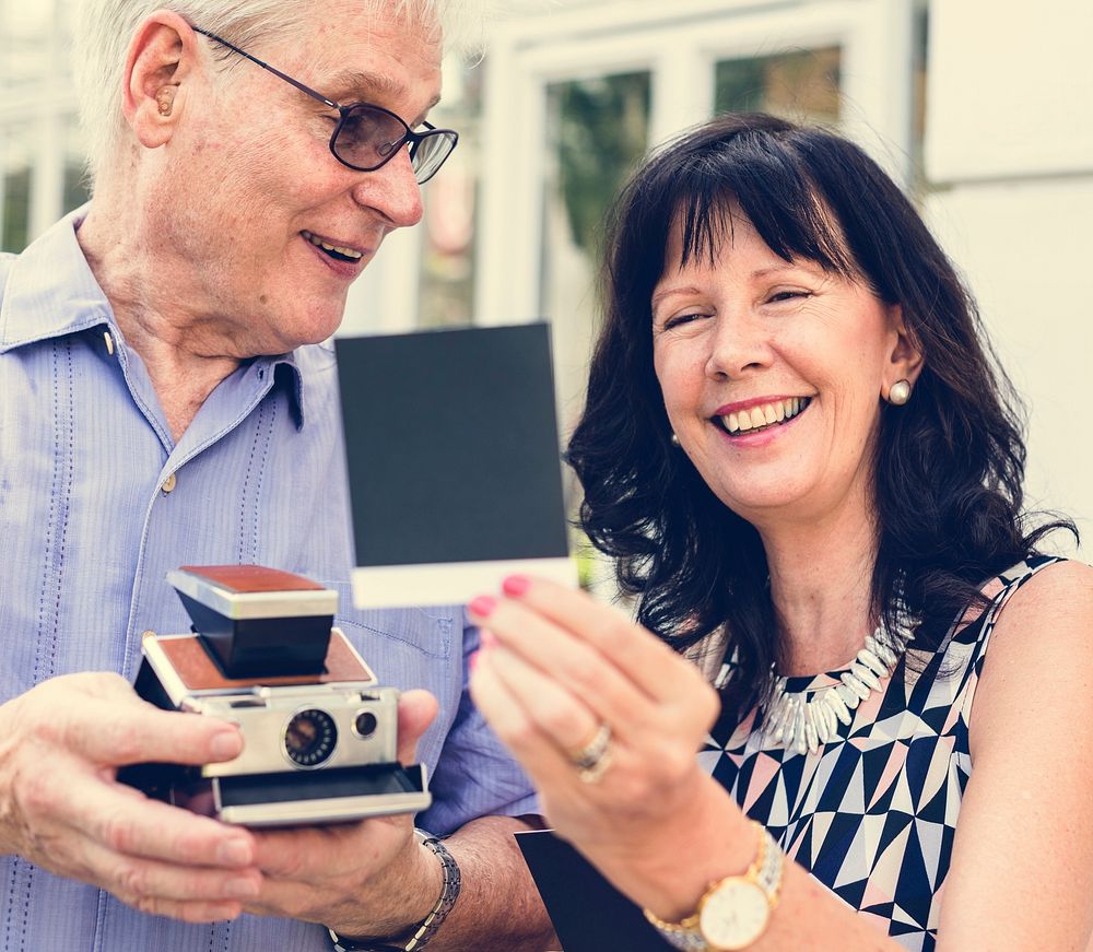 Close up couple checking instant camera image
