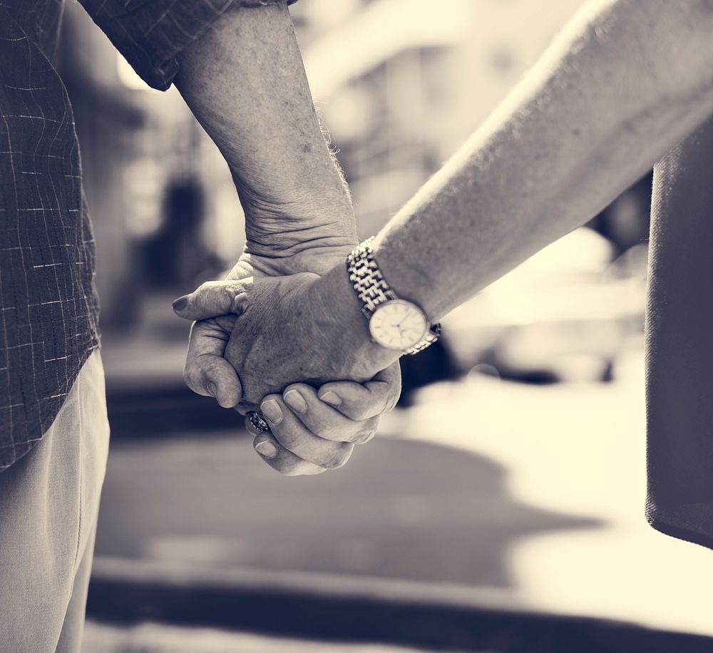 Mature people romantic holding hands