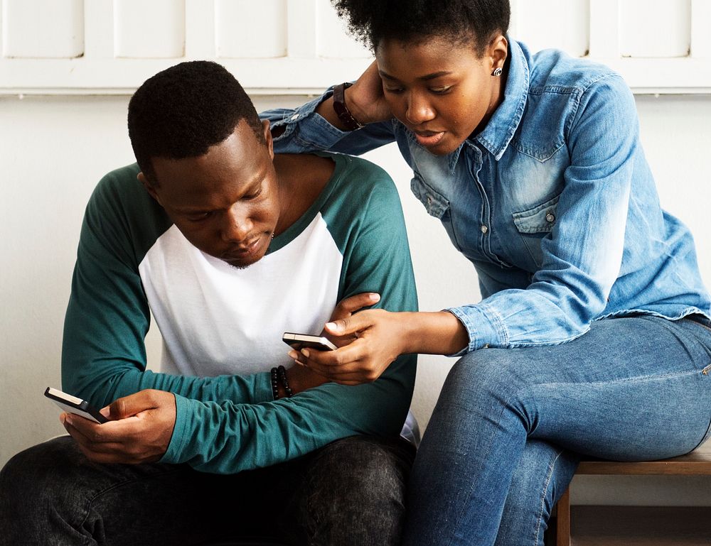 Young african couple using their mobile phones
