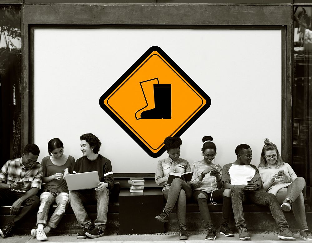 Group of Friends Sitting Together with Safety Boots Attention Banner Behind