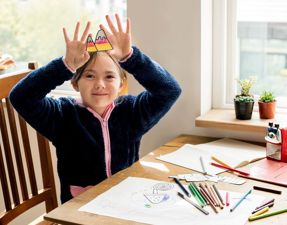 Little girl enjoying coloring paper
