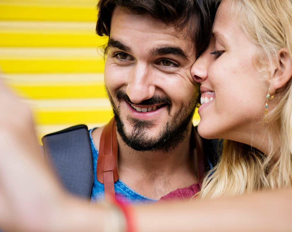 Couple taking a sweet mobile selfie