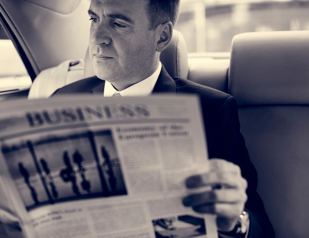 Businessman Reading Newspaper Car Inside