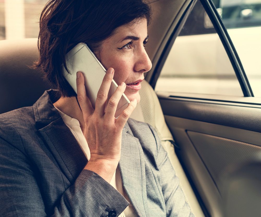Businesswoman Talking Using Phone Car Inside