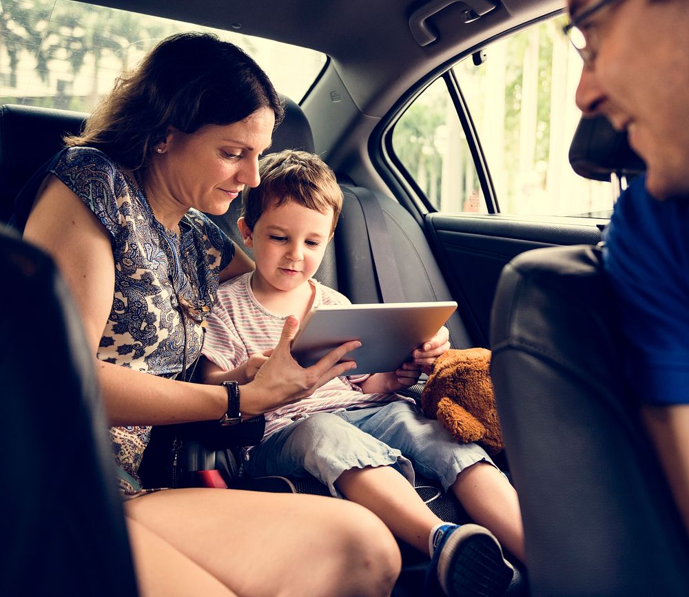 Son and Mom Using Tablet on the Car