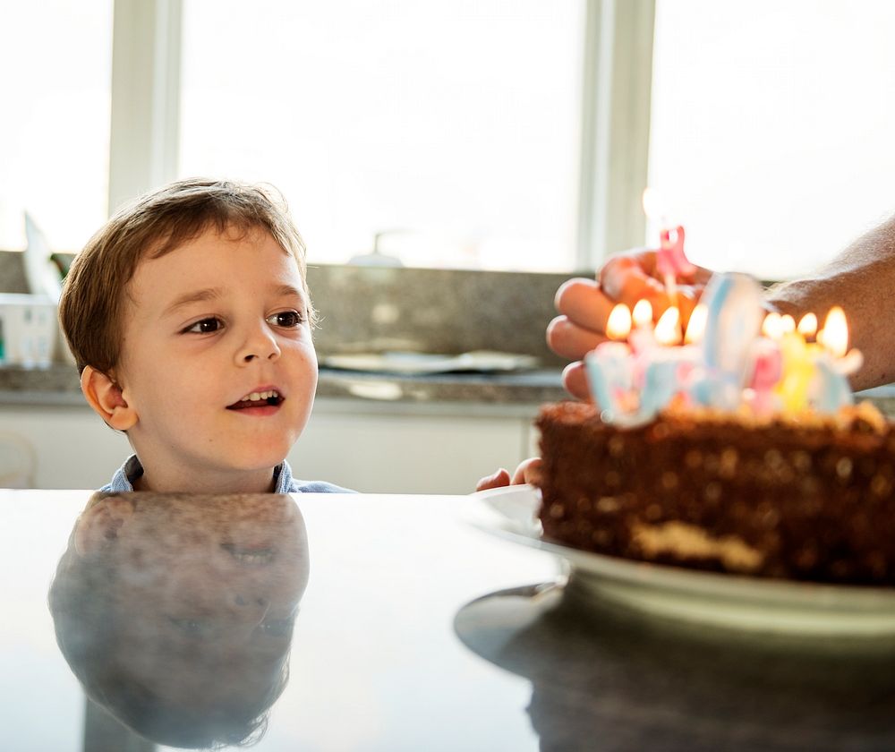 Boy celebrating his birthday with a cake