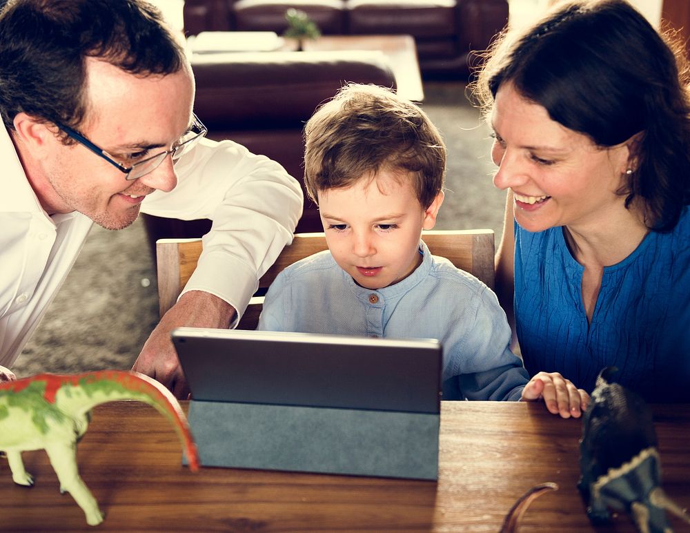 Mom Dad and Son Watching Tablet Spend Time Holiday Together