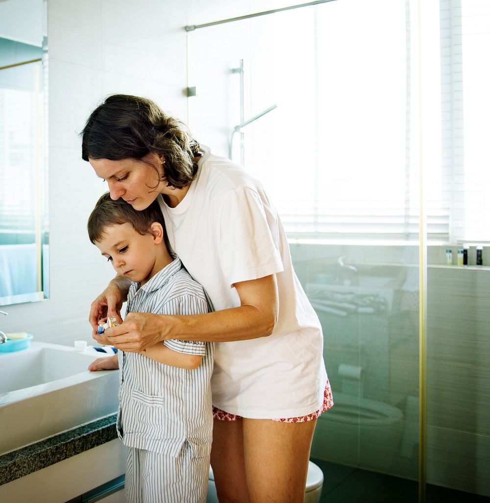 Mom Teaching Son Use Toothbrush in the Toilet