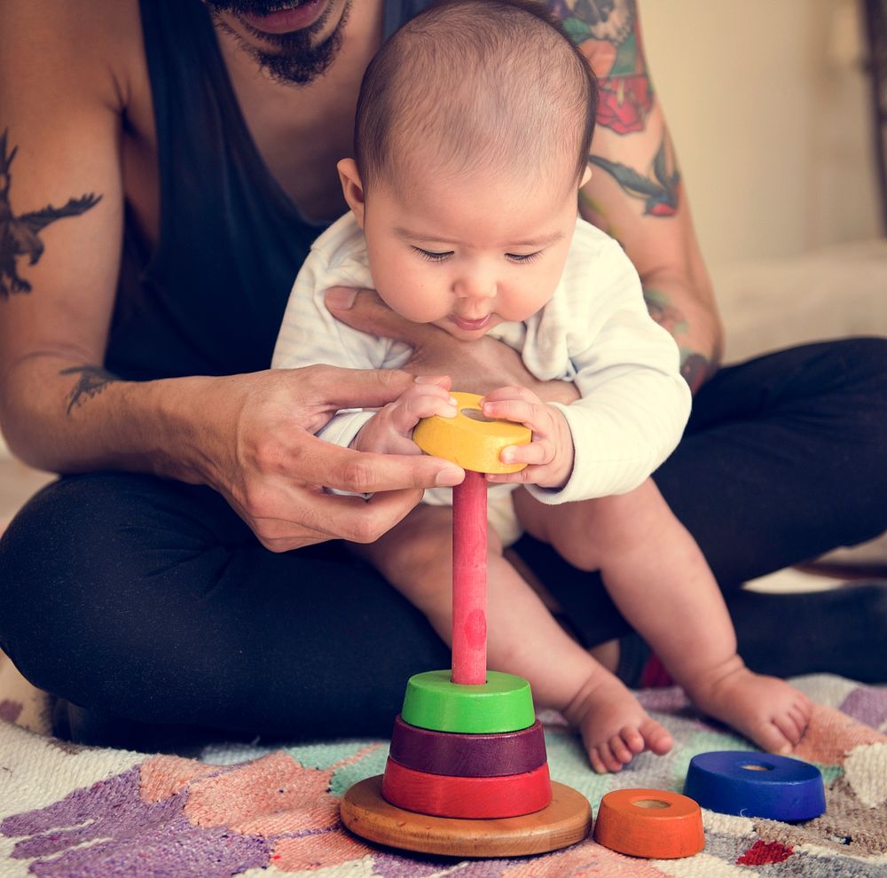 Baby Playing Wooden Toy with Daddy