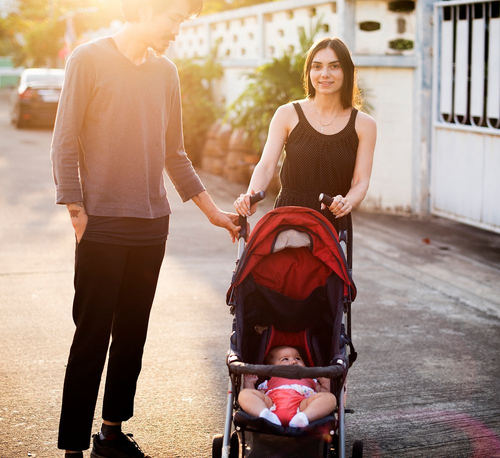 Husband Wife Walking Outdoors with Baby in the Cart