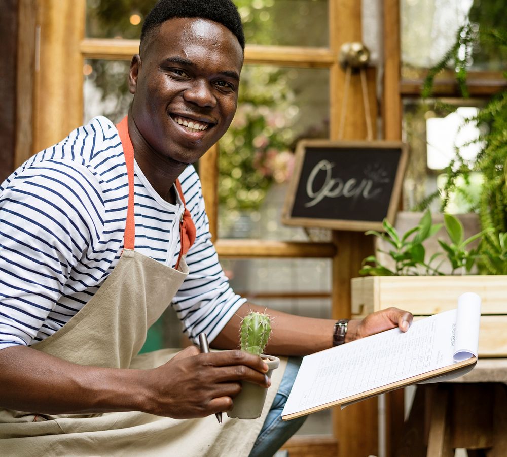 Adult Man Checking Plants Outside Flower Shop