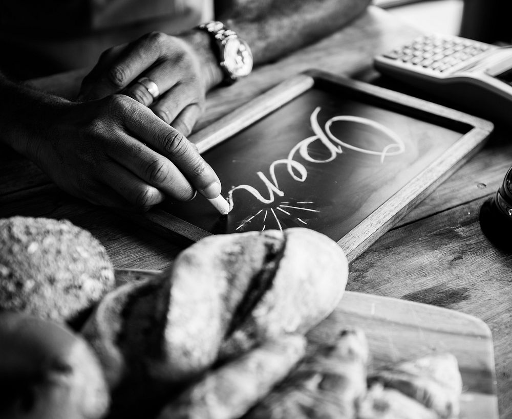 People Hand Writing Open on Chalk Board