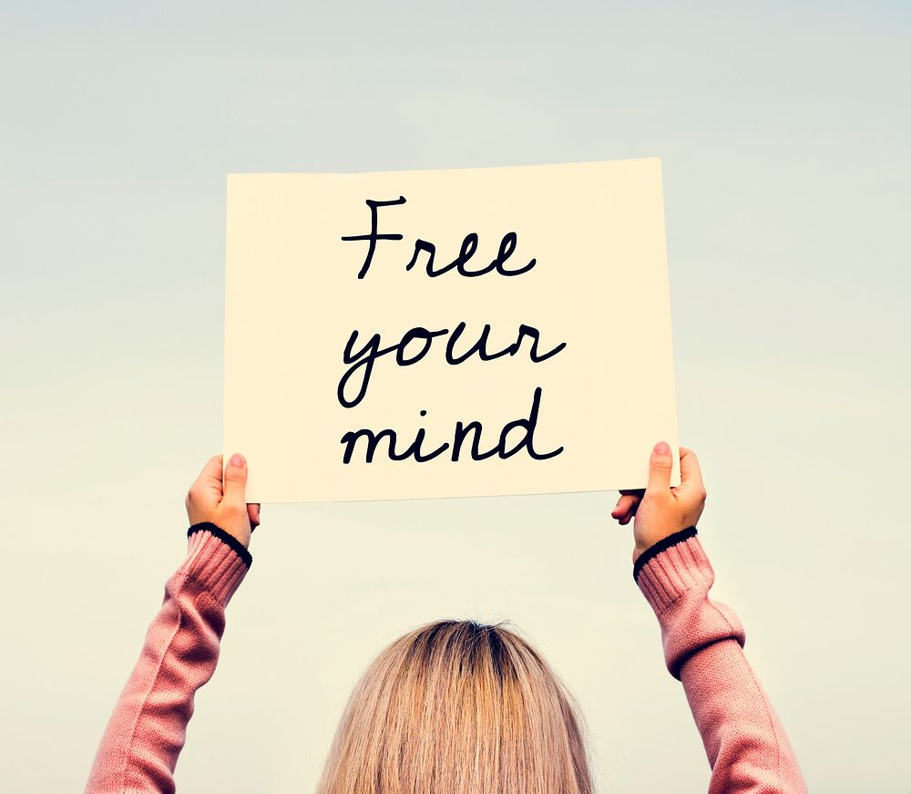 Woman holding up a 'Free your mind' placard