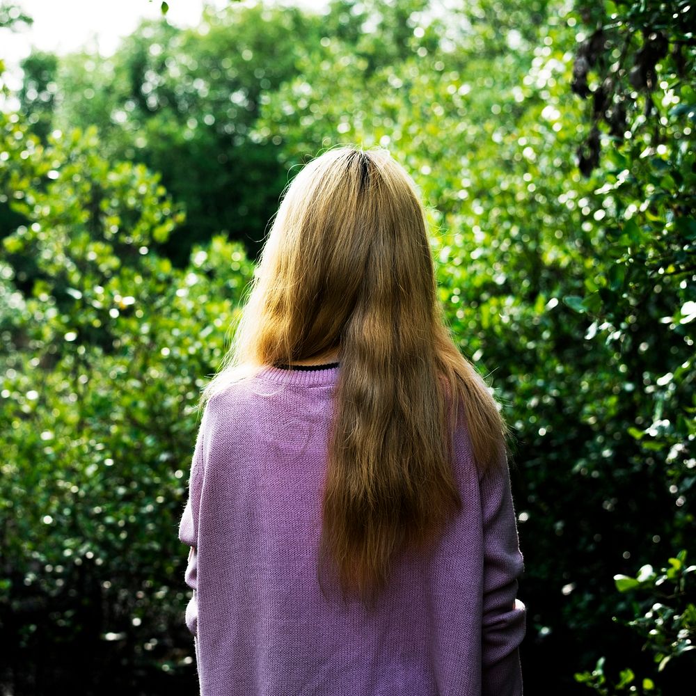 Rear view of woman with long hair in the garden