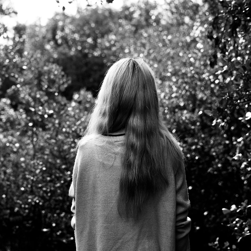 Rear view of woman with long hair in the garden