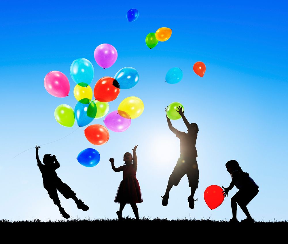Children Outdoors Playing Balloons Together