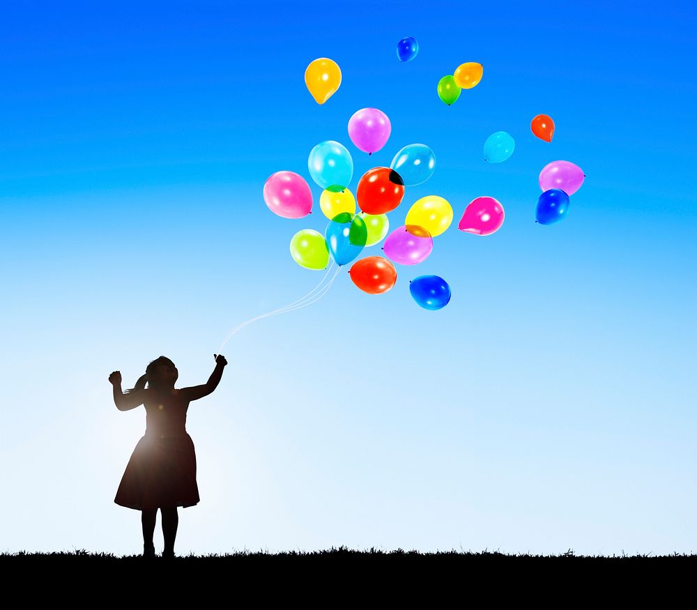 Silhouette of a Little Girl with Balloons and Copy Space
