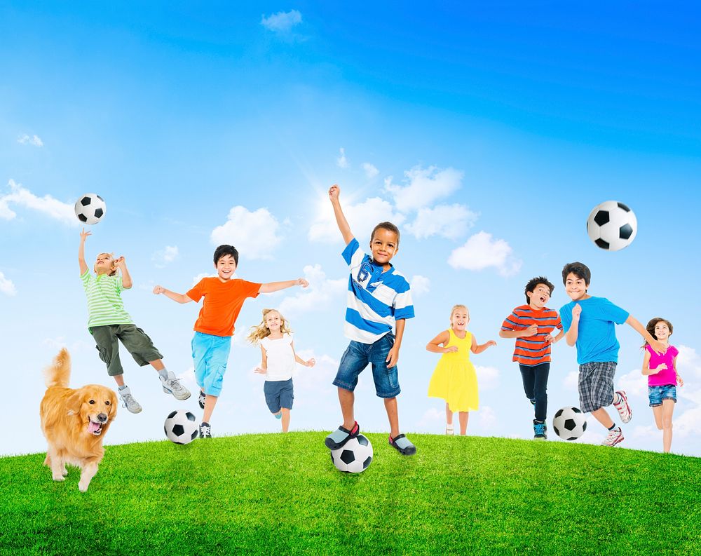Multi-Ethnic Children Outdoors Playing Soccer Together and a Pet Dog