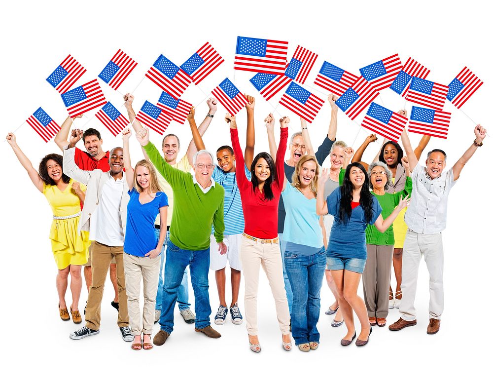 Cheerful Multi-Ethnic Group Of People Standing With Their Arms Raised Holding North American Flag.