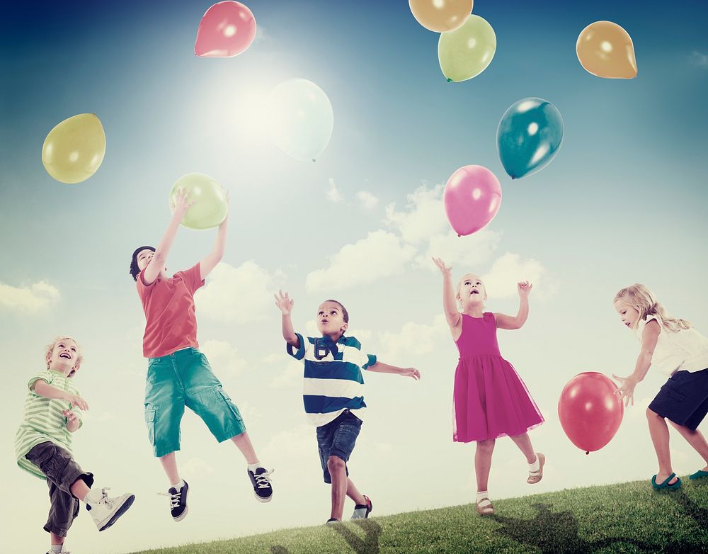 Multi-Ethnic Children Outdoors Playing Balloons Together