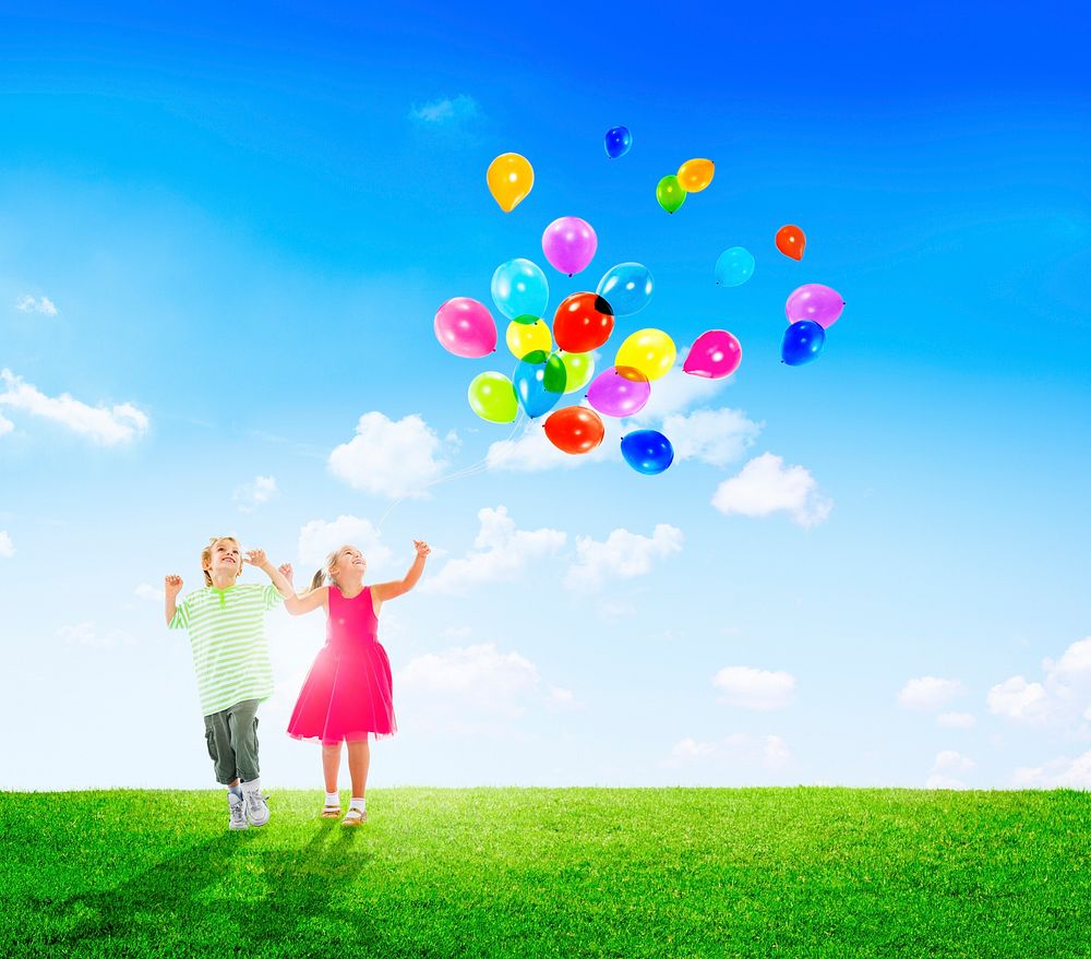 Cheerful Children Playing Balloons Outdoors