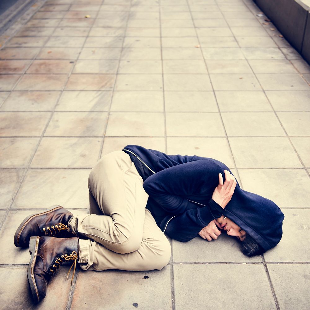 Young man homeless sleep on the street