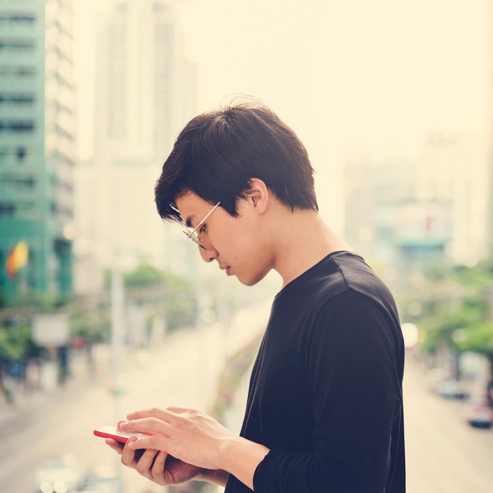 Asian man using mobile phone connection technology