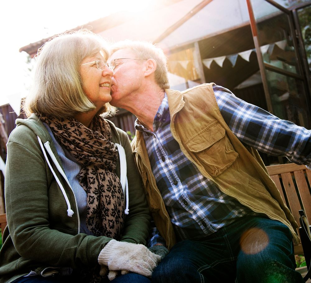 Senior Couple Man Giving Woman a Cheek Kiss