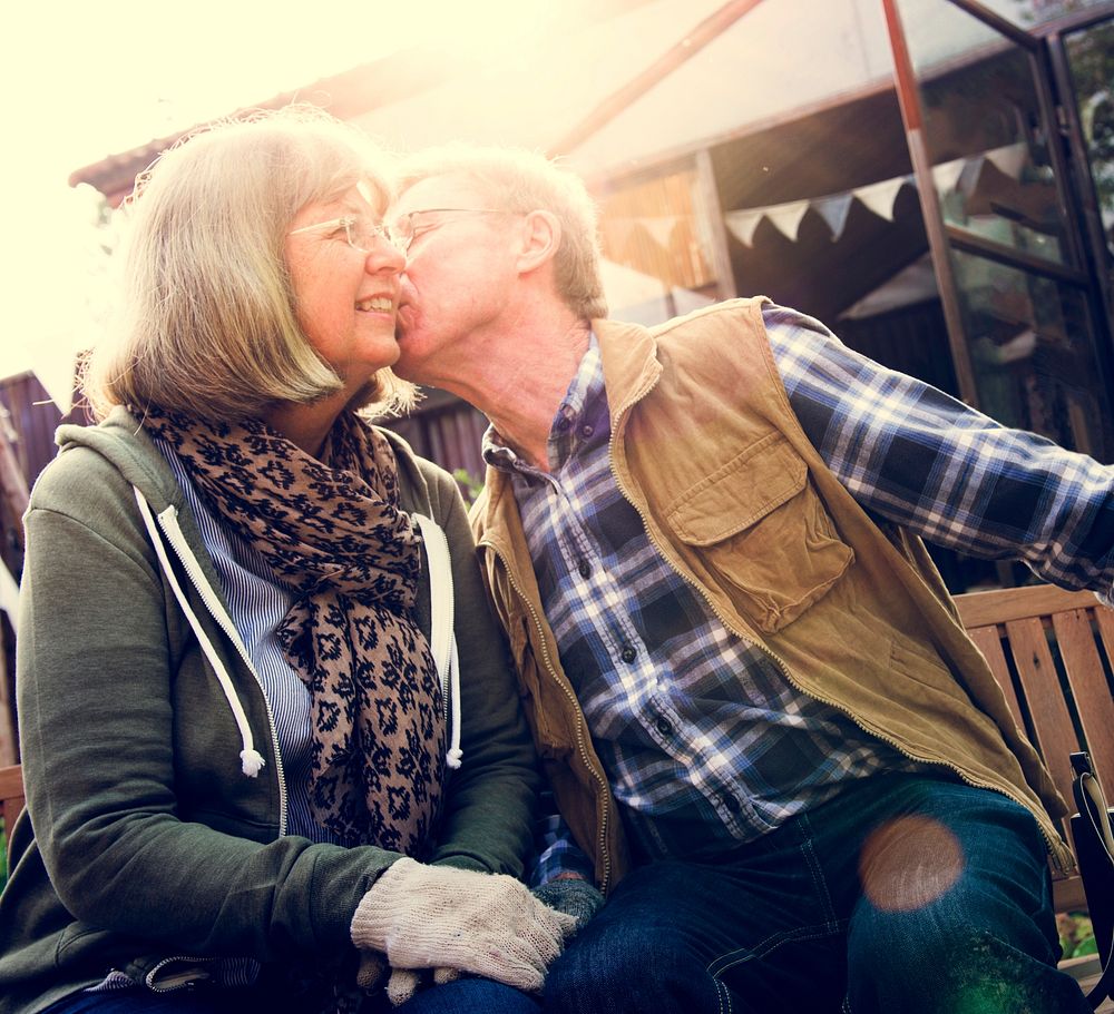 Senior Couple Man Giving Woman a Cheek Kiss