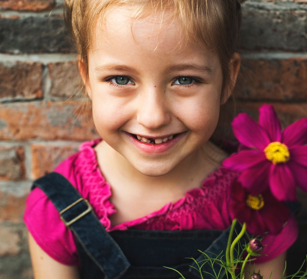 A girl is smiling with flower