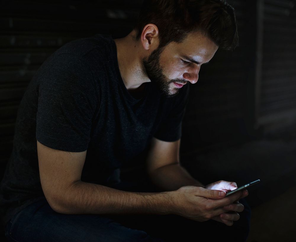 Man Using Mobile Phone in the Dark