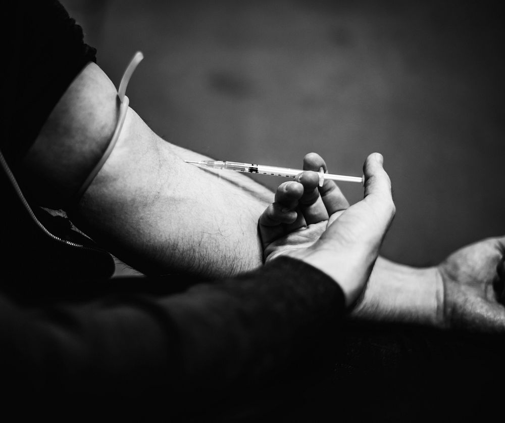 Closeup of Hands Using Syringe Injecting Narcotic Illegal Drugs