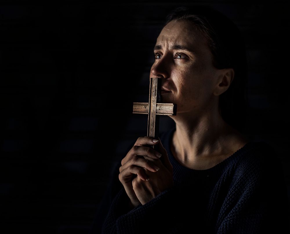 Woman Holding Cross Praying for God