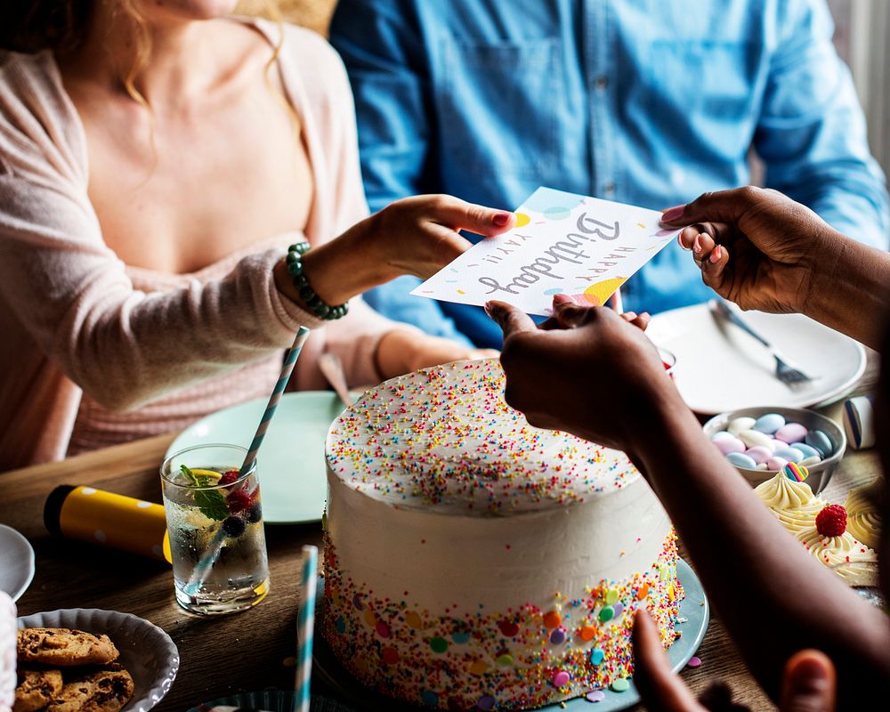 People celebrate birthday party with cake and card