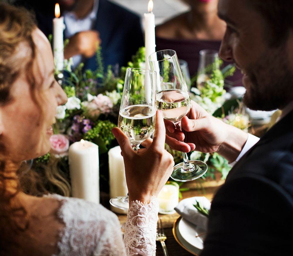 Bride and Groom Toasting with Wine Glasses at a Wedding Reception