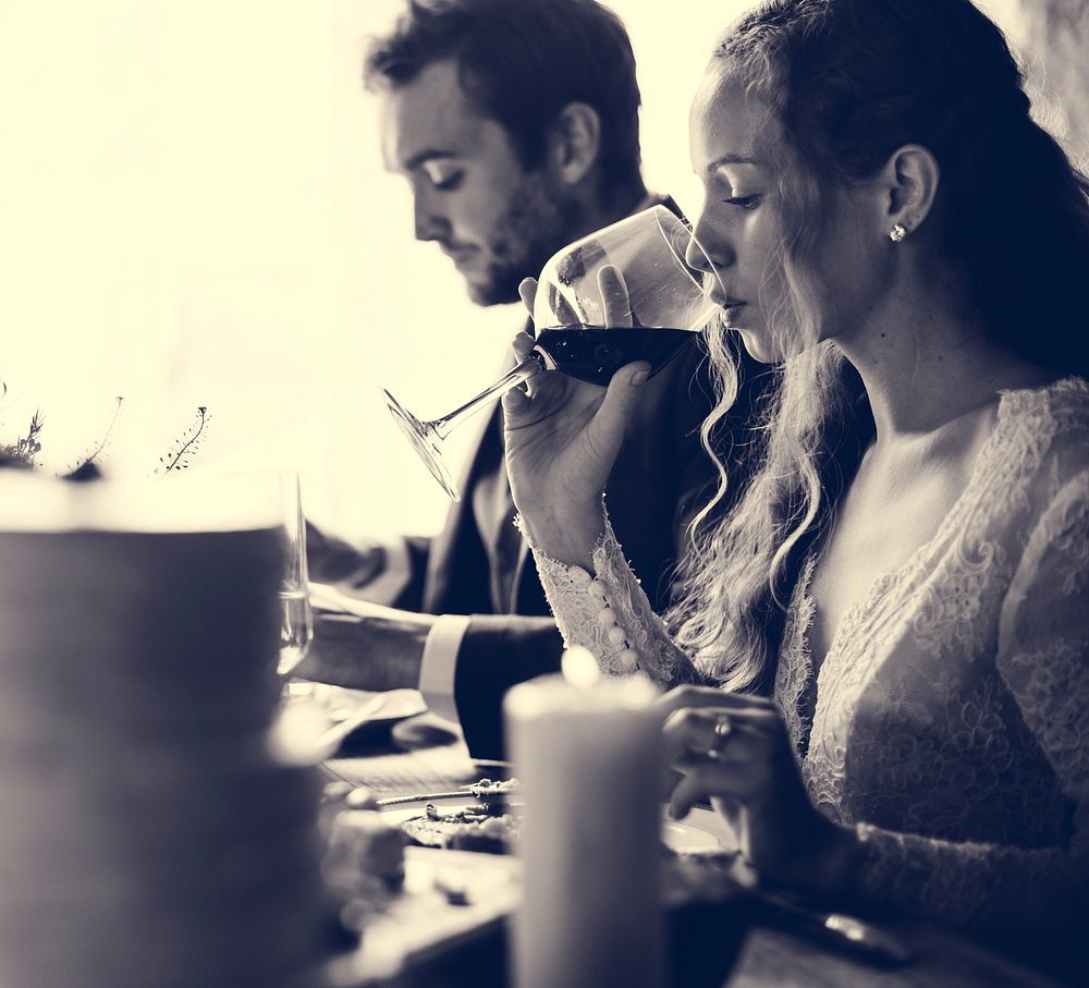 Bride drinking a glass of red wine