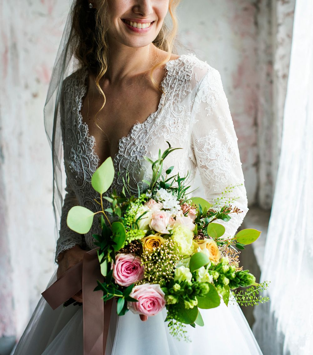 Bride in her wedding dress holding a bouquet of flowers